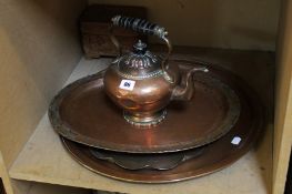 An Arts & Crafts hammered copper tray, two others, a kettle and a carved treen box
