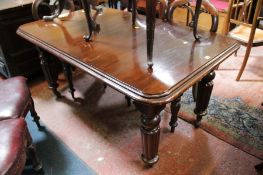A Victorian mahogany dining table on baluster turned and fluted tapering legs