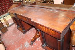 A George IV mahogany inverted breakfront pedestal sideboard with three frieze drawers and two