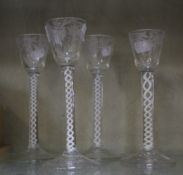 A group of four 20th Century air twist stem glasses with foliate decoration to the bowls