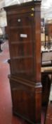 A mahogany corner cupboard, a fretwork mirror, a rectangular wall mirror and a Regency armchair