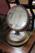 A Victorian mahogany toilet mirror on a marble circular stand