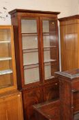 Victorian mahogany library bookcase with a glazed upper section over panelled doors.