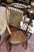 A 19th century oak, ash, elm and yew wood Windsor elbow armchair with high spindle back on turned