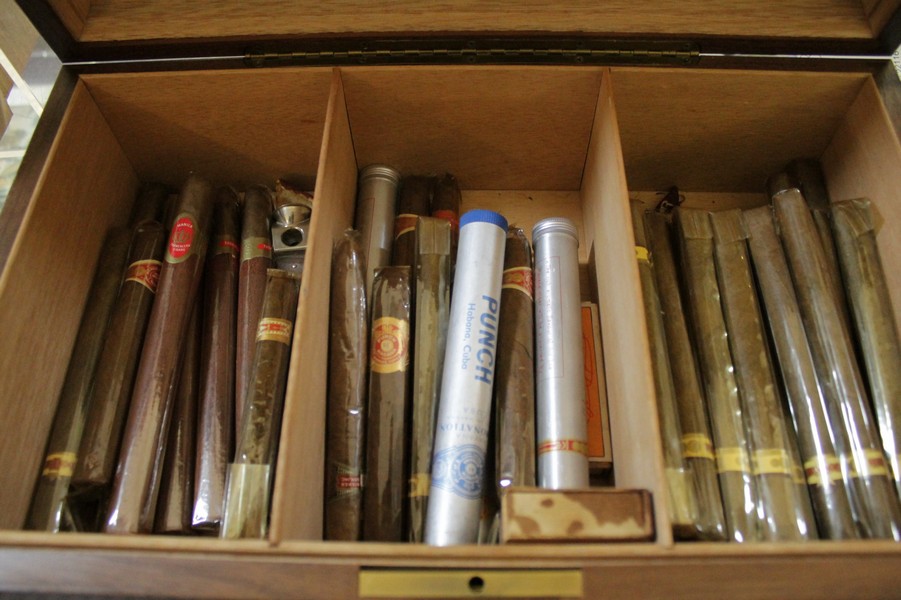 A walnut humidor and quantity of cigars