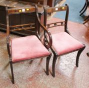 A set of eight mahogany dining chairs in the Regency style raised on sabre supports.(6+2)