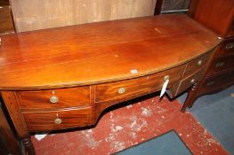 An early 19th century mahogany serpentine sideboard.