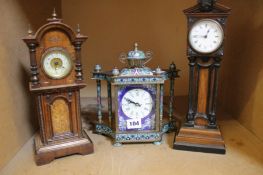 Two Edwardian walnut mantel timepieces modelled as miniature longcase clocks, each with French