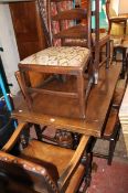 A 17th century style oak draw-leaf dining table, having ?cup and cover? supports, and a set of