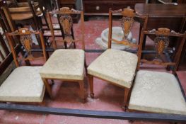 Four Edwardian Sheraton Revival salon chairs.