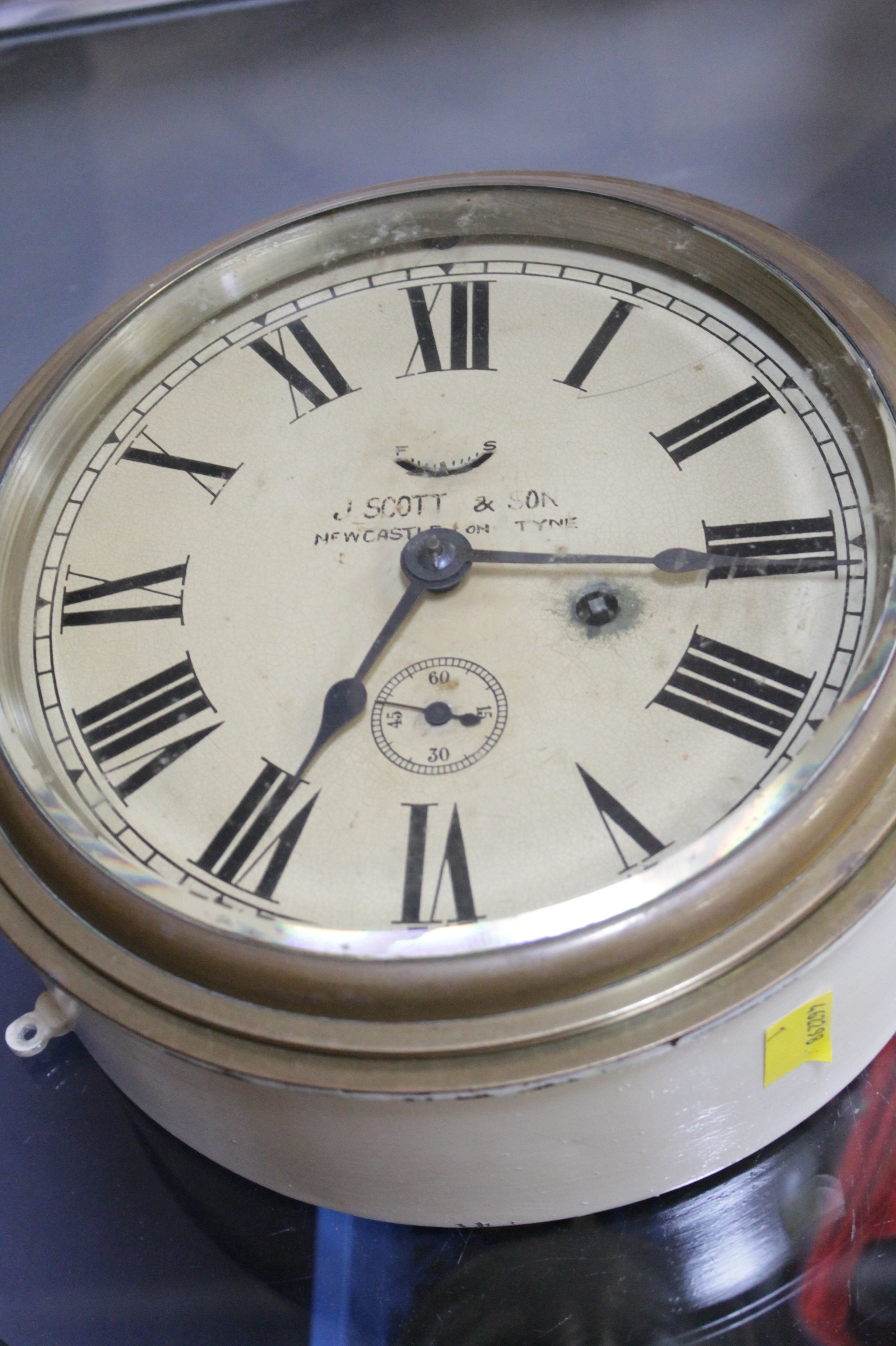 Ships patten wall mounted clock, with Roman numeral dial, `J. Scott & Son - Newcastle on Tyne` to