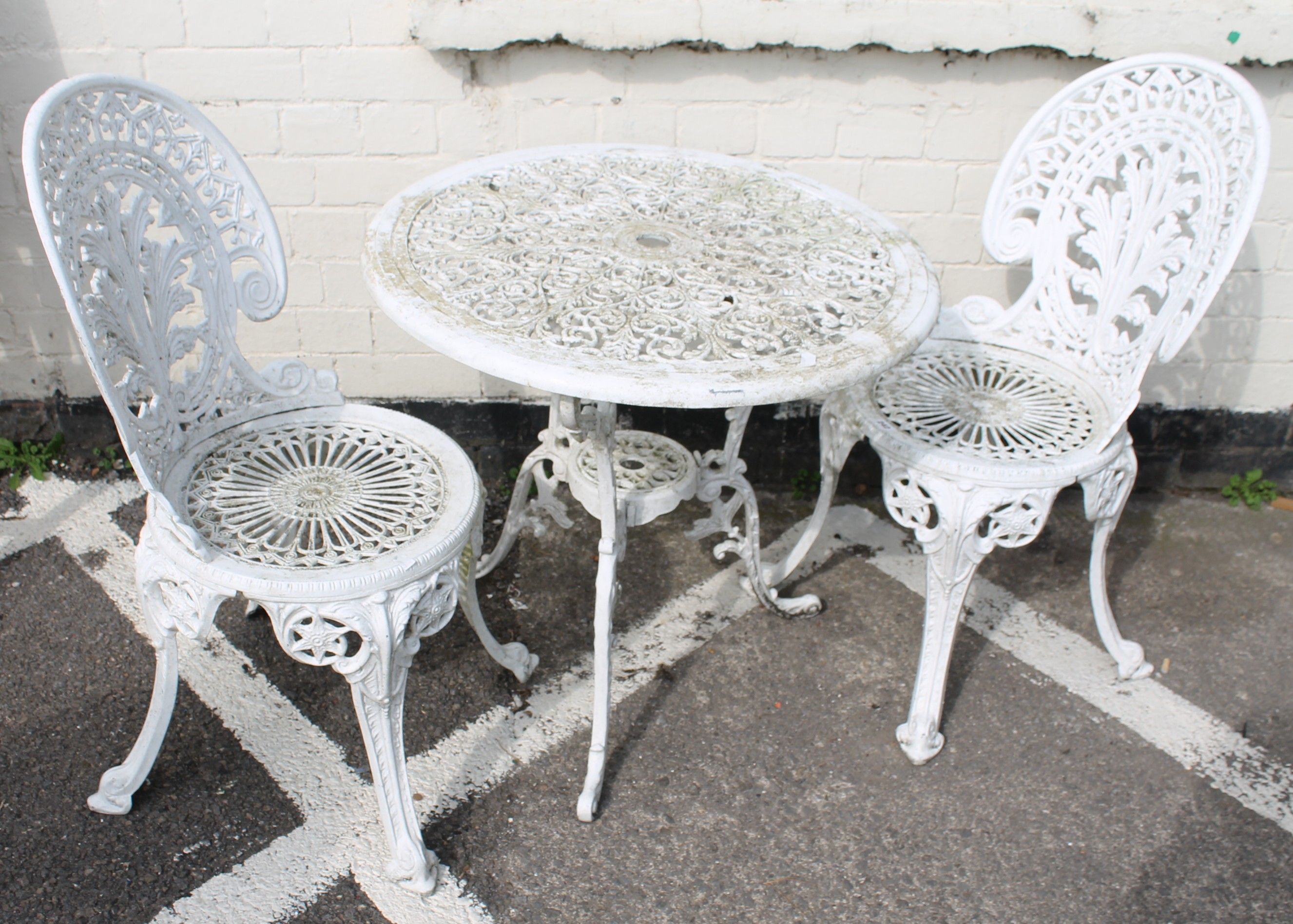 A painted cast iron table and two chairs  Best Bid