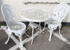 A painted cast iron table and two chairs  Best Bid