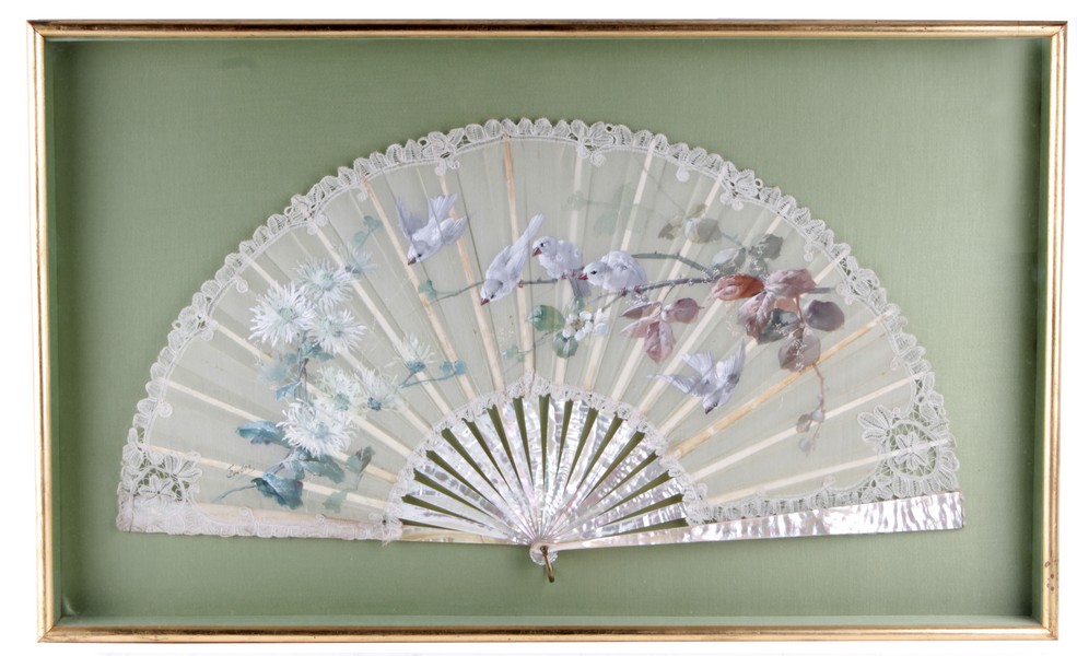 A large 19th century mother of pearl fan, with a painted design of birds and flowers edged in lace,