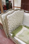 A pair of 19th century French single beds with green crackle finish and silk upholstery.