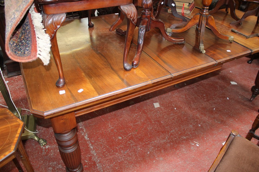 A Victorian walnut extending dining table and eight chairs