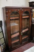 A Victorian mahogany bookcase with arched glazed doors 164cm high, 124cm wide