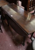 A Georgian oval drop leaf supper table with turned tapering legs and pad feet