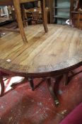 A Regency rosewood and brass inlaid breakfast table, circa 1825, on shaped support and platform and