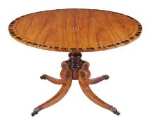 A Regency mahogany and coromandel crossbanded circular centre table, circa 1815, the top with