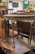 A Georgian style demi lune hall table on cabriole supports.