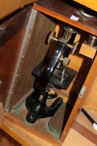 A cased microscope and a bayonet