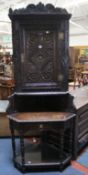 A heavily carved oak Victorian corner cupboard.