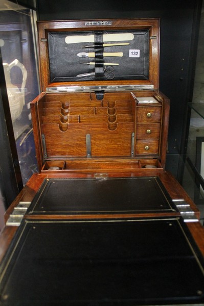 An oak stationery box; 29cm high x 36cm wide