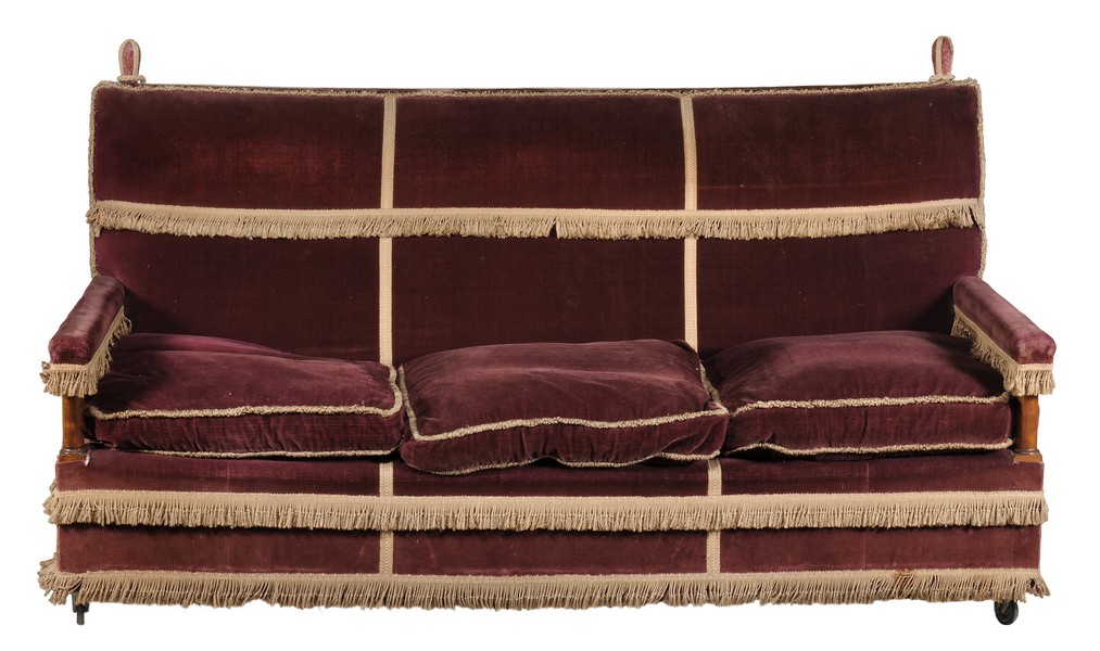 An early 20th century mauve velvet Knole sofa with gold tassle trim.