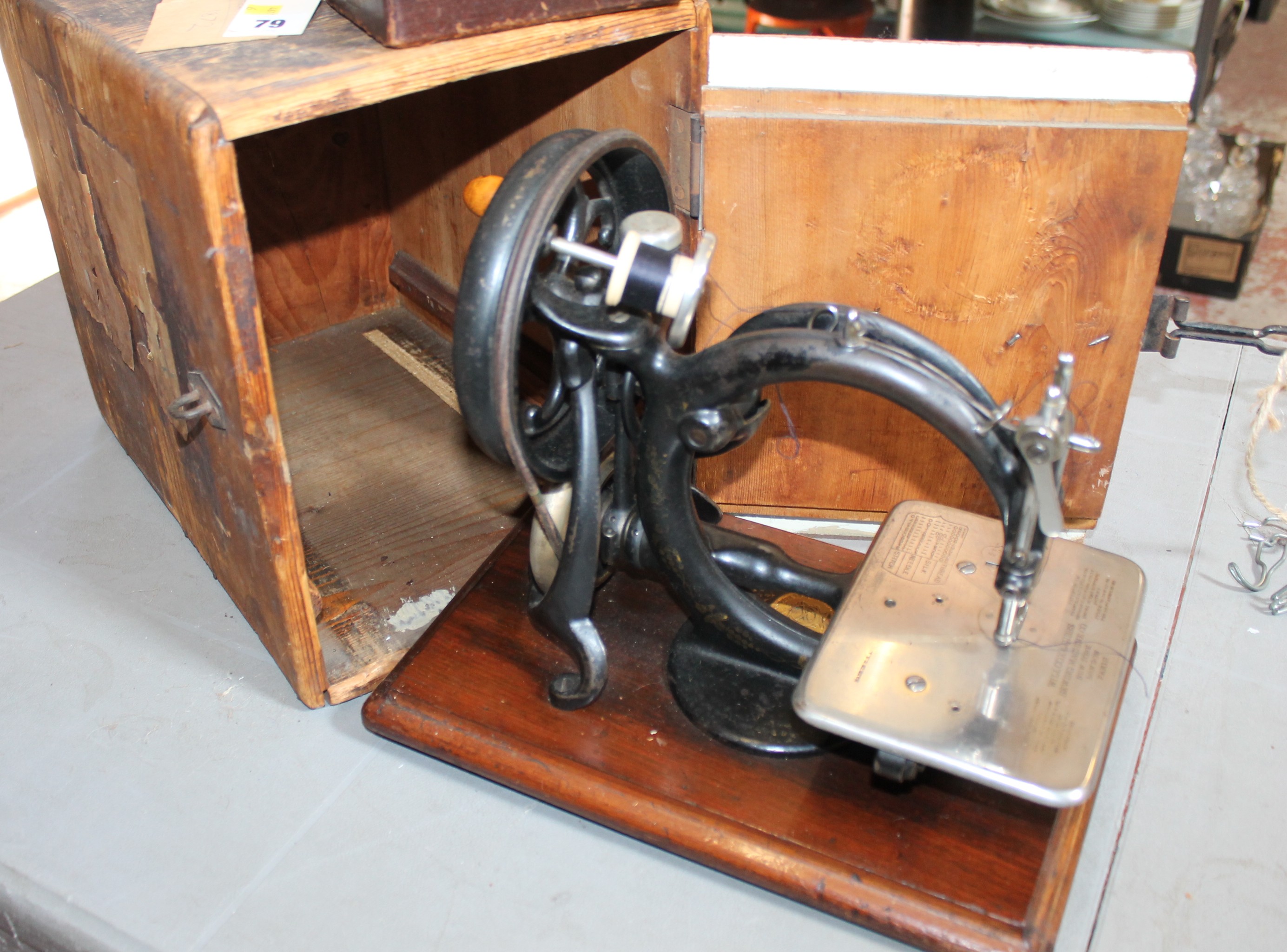 A Wilcox & Gibbs sewing machine with wooden box