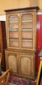A Victorian glazed library bookcase with beaded doors below.