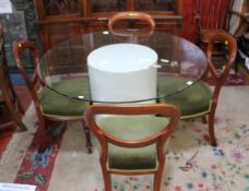 A circular plate glass top dining table on a white column base.120cm diam.