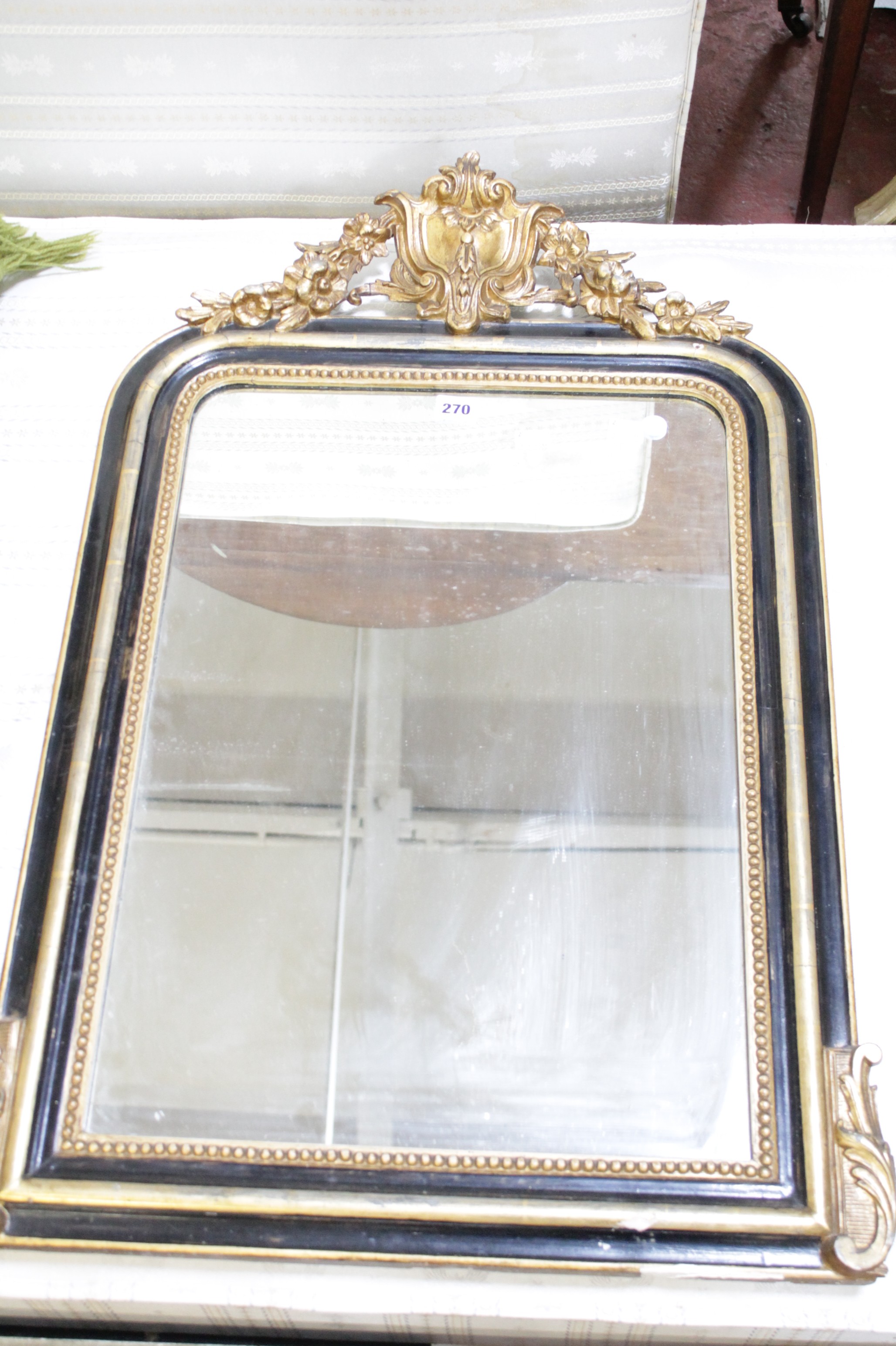A19th Century ebonised and gilt wall mirror and a green casa pupo green rug  Best Bid