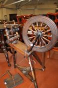 A 19th century fruitwood and pine spinning wheel, stamped `W. Waters, Wick`, 84cm high and teaser.