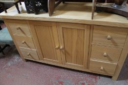 A modern pine sideboard with central cupboard flanked by drawers 150cm length  Best Bid