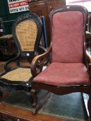 A Victorian Rocking chair and caned back ebony nursing chair