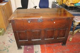 An 18th Century oak mule chest with a hinged lid and fielded panel front 94cm high, 143cm wide