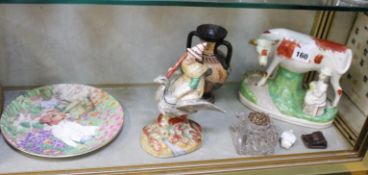 A mixed lot to include a 19th Century Staffordshire group of milkmaid and cow, another of a witch,