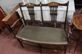 An Edwardian mahogany and inlaid two seat settle and an occasional table (2)