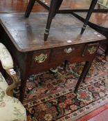 A George II oak side table with three frieze drawers with a shaped apron on turned tapering legs