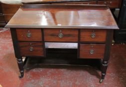 A 19th Century mahogany kneehole dressing table with four short drawers on reeded tapering legs