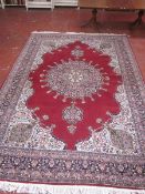 A Tabriz style red ground rug with central medallion 375 x 257cm