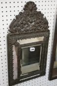 A Low Countries repousse brass framed wall mirror, late 19th century 60cm high, 33cm wide