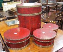 An oak corner cupboard and a set of graduated drum boxes in a red leather effect finish.