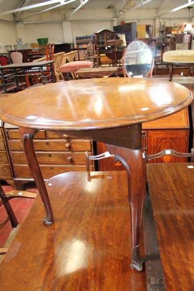 A circular top table possibly Irish, on a triangular frame with three cabriole legs