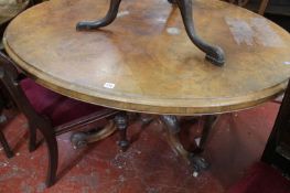 A Victorian oval walnut loo table on swept supports.