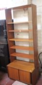 A G Plan bookcase with cabinet base and a G Plan nest of three tables.