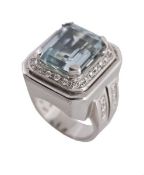 An aquamarine and diamond ring, the rectangular step cut aquamarine in a four claw setting, within a