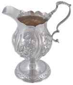 A George III silver baluster cream jug by Robert Hennell I, London 1773, with a leaf-capped double s