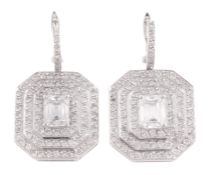 A pair of diamond ear pendents, each set with an octagonal panel, centrally set with a rectangular s